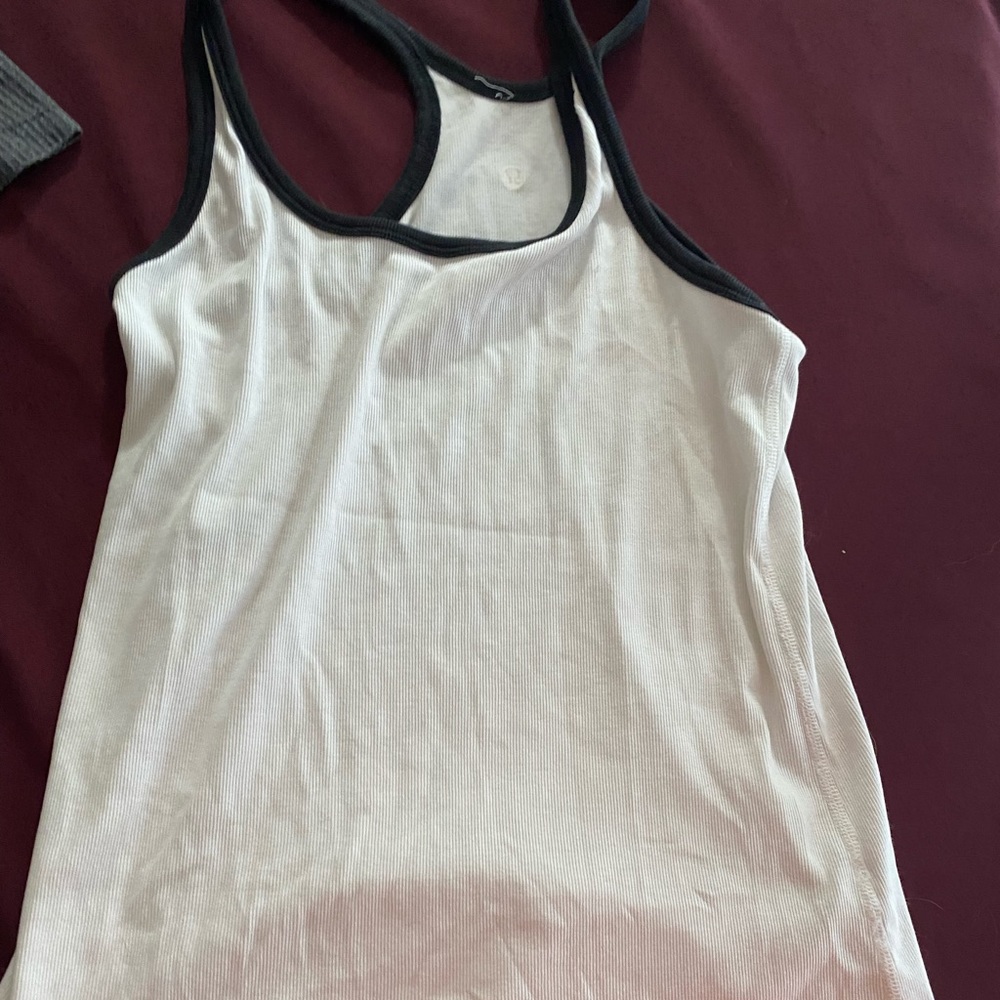 Lululemon tank- size 6? pin hole in upper left chest area. Price reflects.